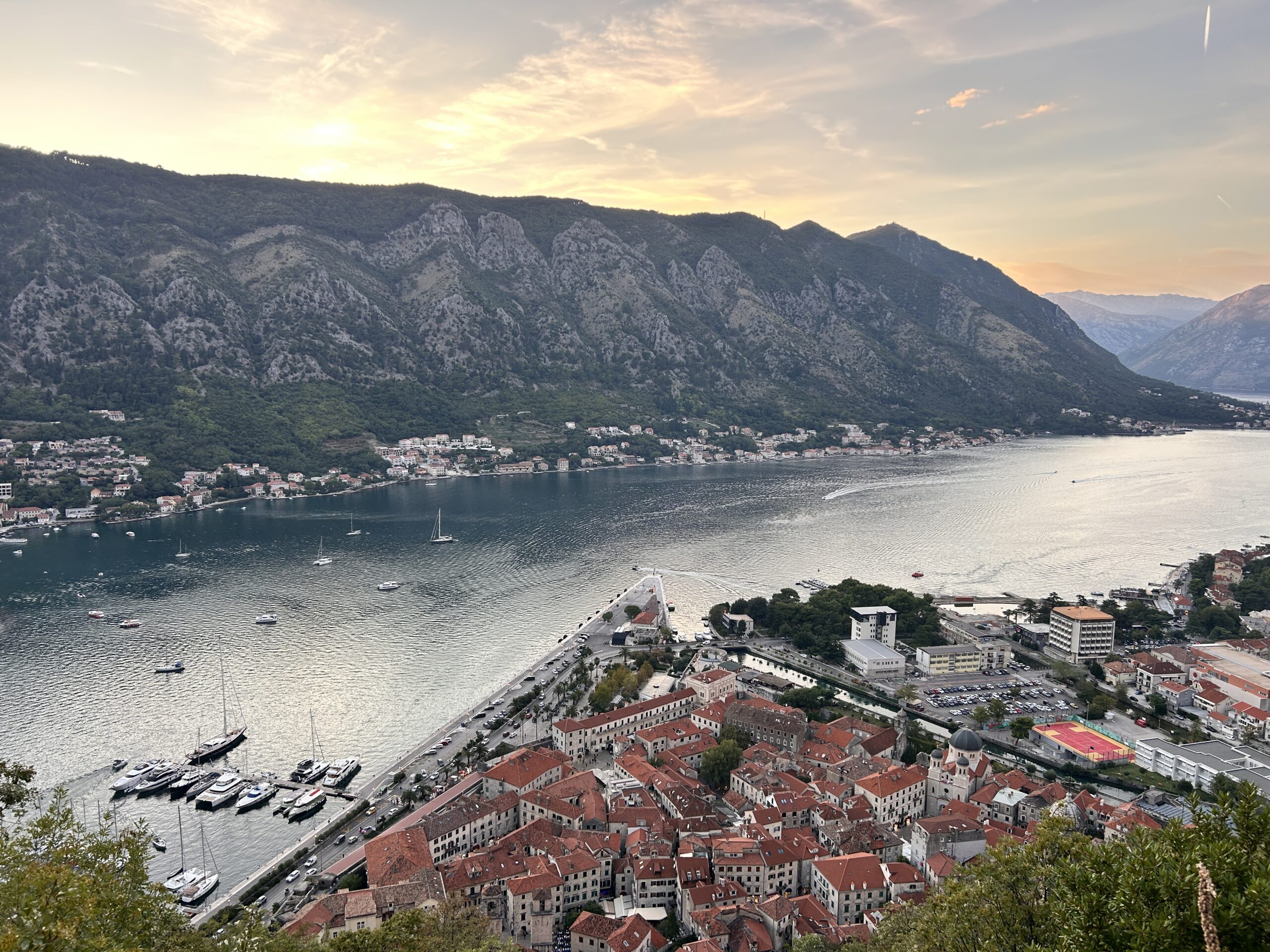 View of Kotor and the Bay of Kotor at sunset, one of the best places to visit in Montenegro, easily reached through Montenegro flights to Tivat and Podgorica.