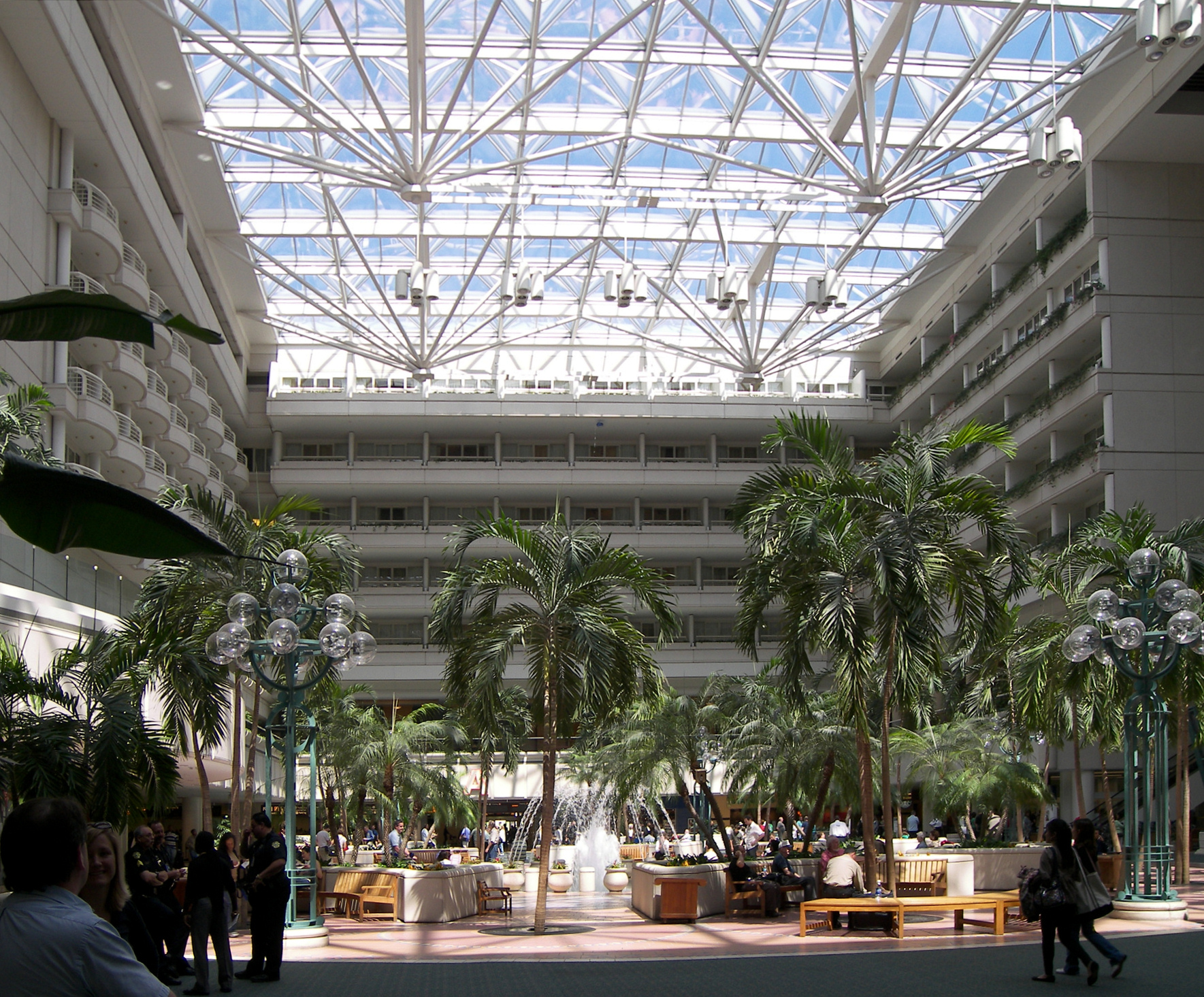 The inside of Orlando international airport, with a large skylight illuminating some palm trees.