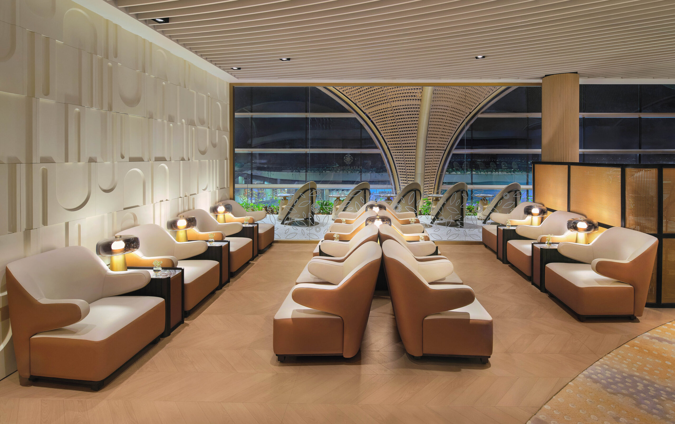Rows of lounge chairs are lined up in the airport lounge's relaxation area.