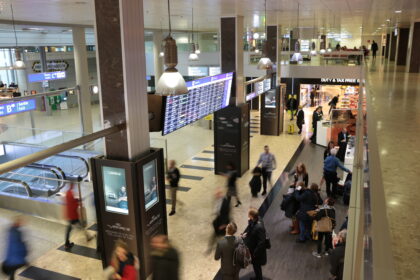 Passenger Experience walking through the lobby at the Geneva Airport.