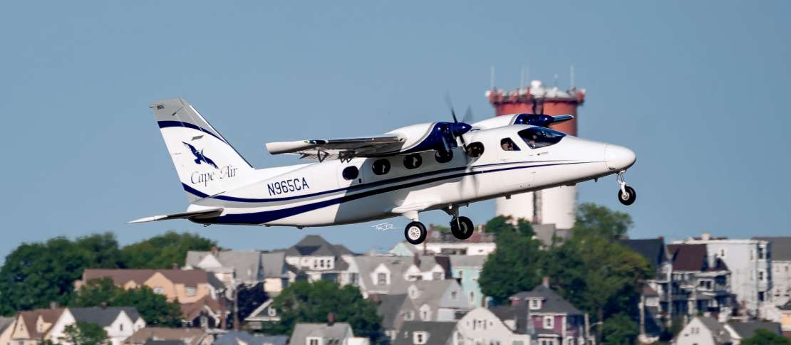 Cape Air regional aircraft taking off over a small airport, illustrating the role of Essential Air Service in supporting rural air travel and the impact of US airline subsidies on regional airlines.