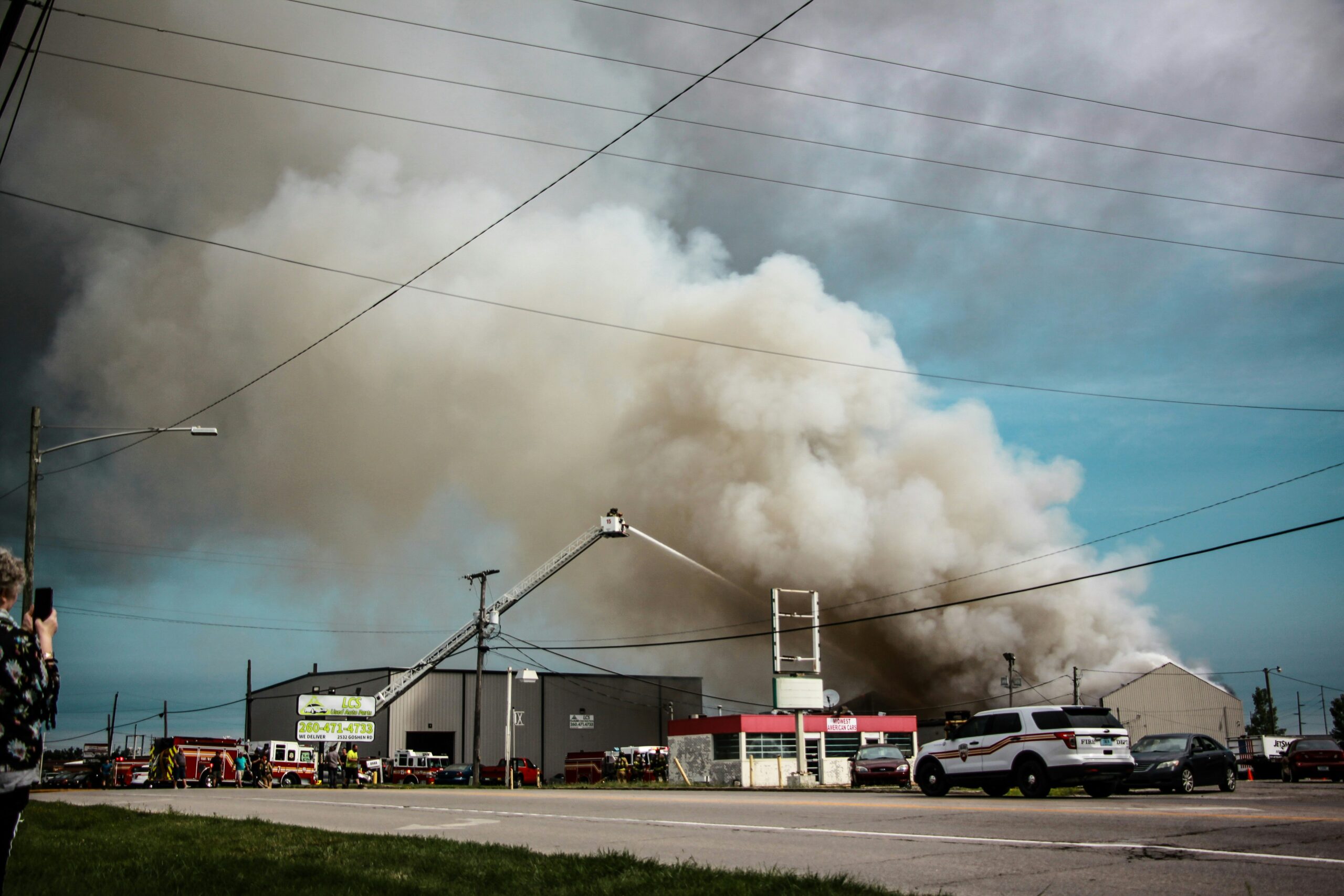 Large explosion surrounded by firestrucks emitting smoke