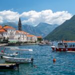 Scenic view of Montenegro’s Bay of Kotor with boats docked near Perast, a top highlight among the best places to visit in Montenegro, attracting travellers through Montenegro flights to Tivat and Podgorica.