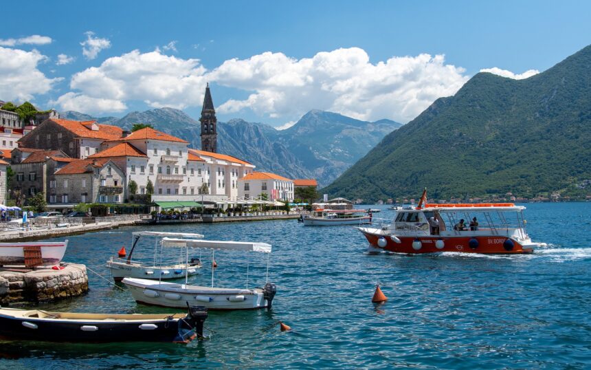 Scenic view of Montenegro’s Bay of Kotor with boats docked near Perast, a top highlight among the best places to visit in Montenegro, attracting travellers through Montenegro flights to Tivat and Podgorica.