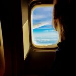 Person sat next to the window on a plane