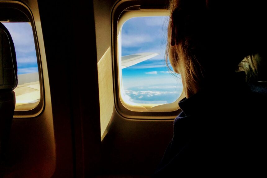 Person sat next to the window on a plane