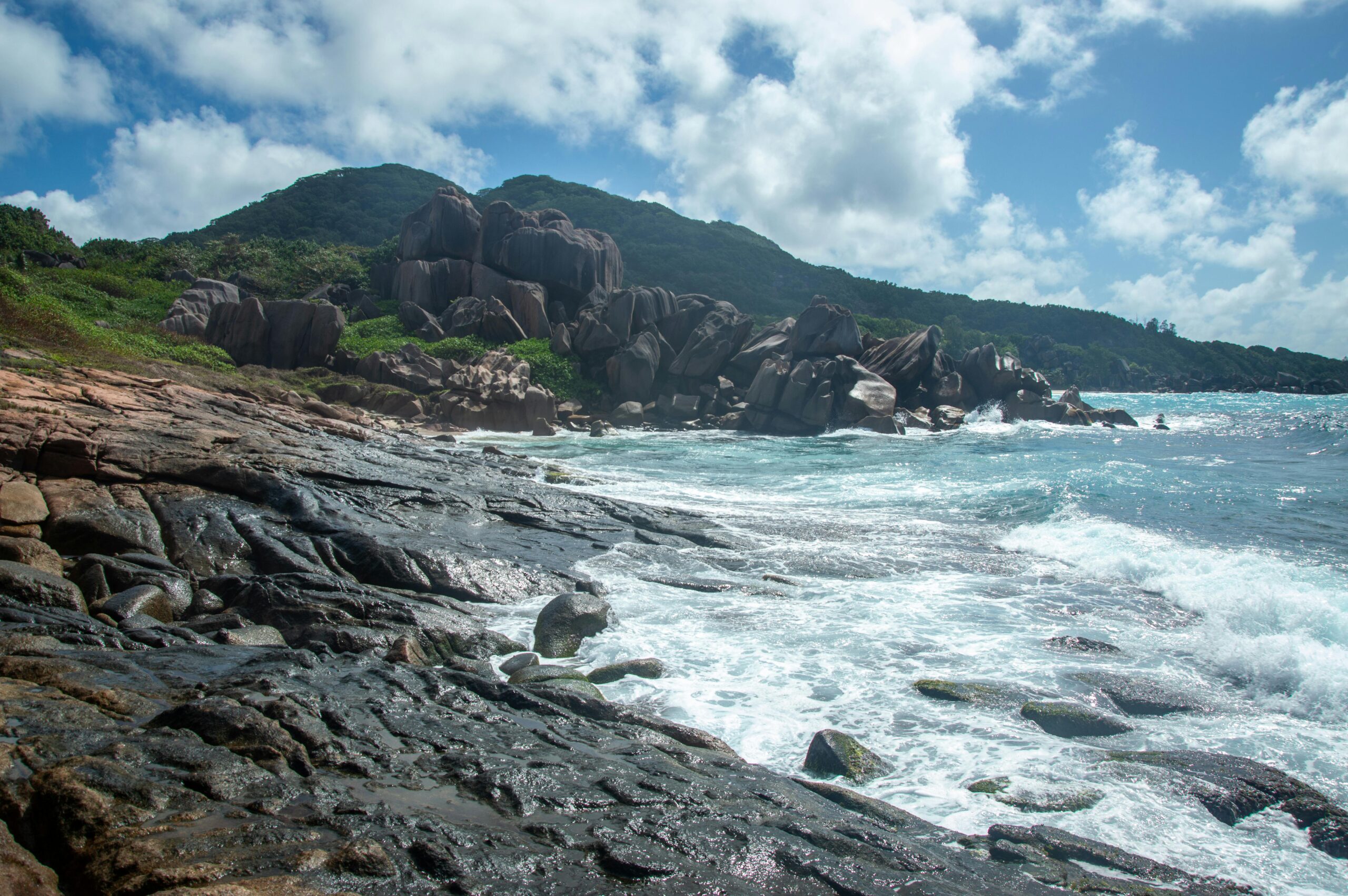 Scenic Coastal Beach with Rocky Hills and Waves