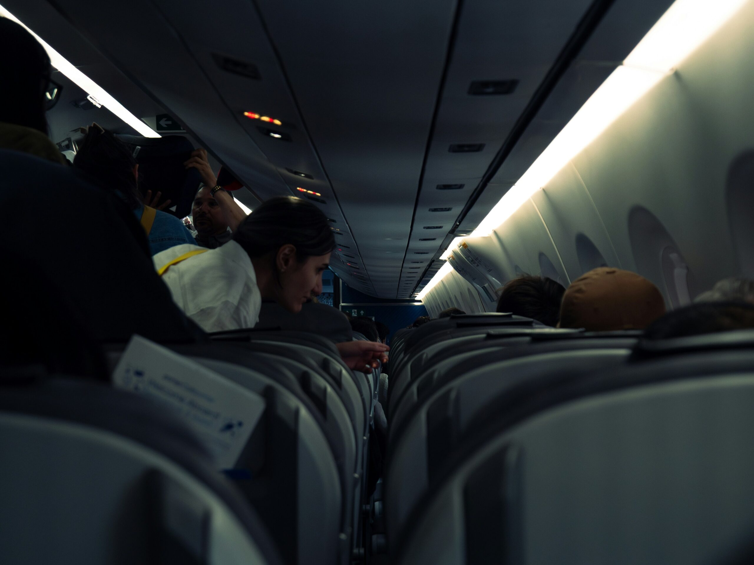 A flight attendant talking to a passenger
