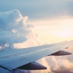 The wing of a plane out of the window mid flight