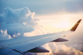The wing of a plane out of the window mid flight