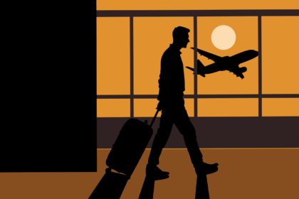 Silhouette of a business traveler walking through an airport terminal with luggage as an airplane takes off at sunset, symbolising business aviation growth 2025 and rising corporate travel demand.