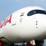 Large Air India jetliner sitting on airport tarmac