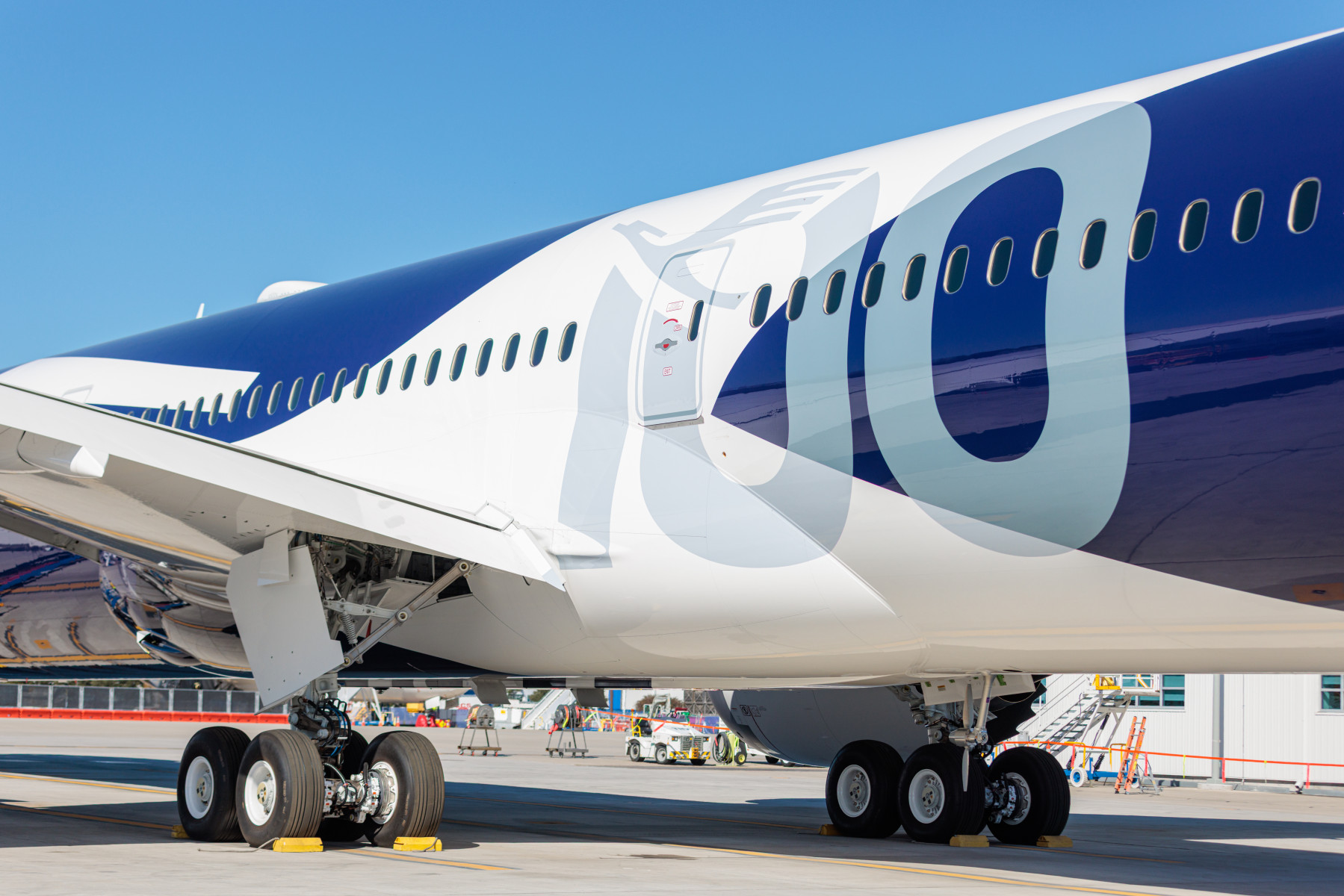The number 100 in blue on the side of the aircraft.