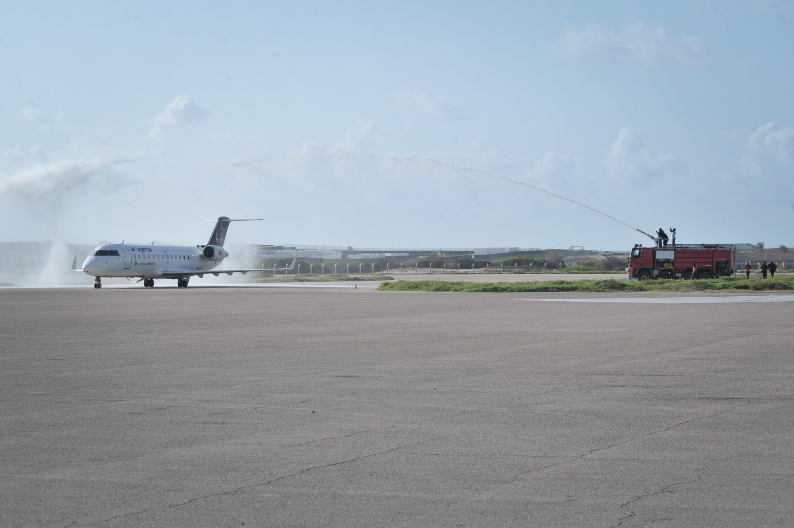 Aircraft receiving a water salute on the runway, symbolising Uganda aviation, the Uganda ICAO Council 2025, Uganda international air service agreements 2025, ICAO Uganda, and Uganda aviation sector expansion ICAN2025.
