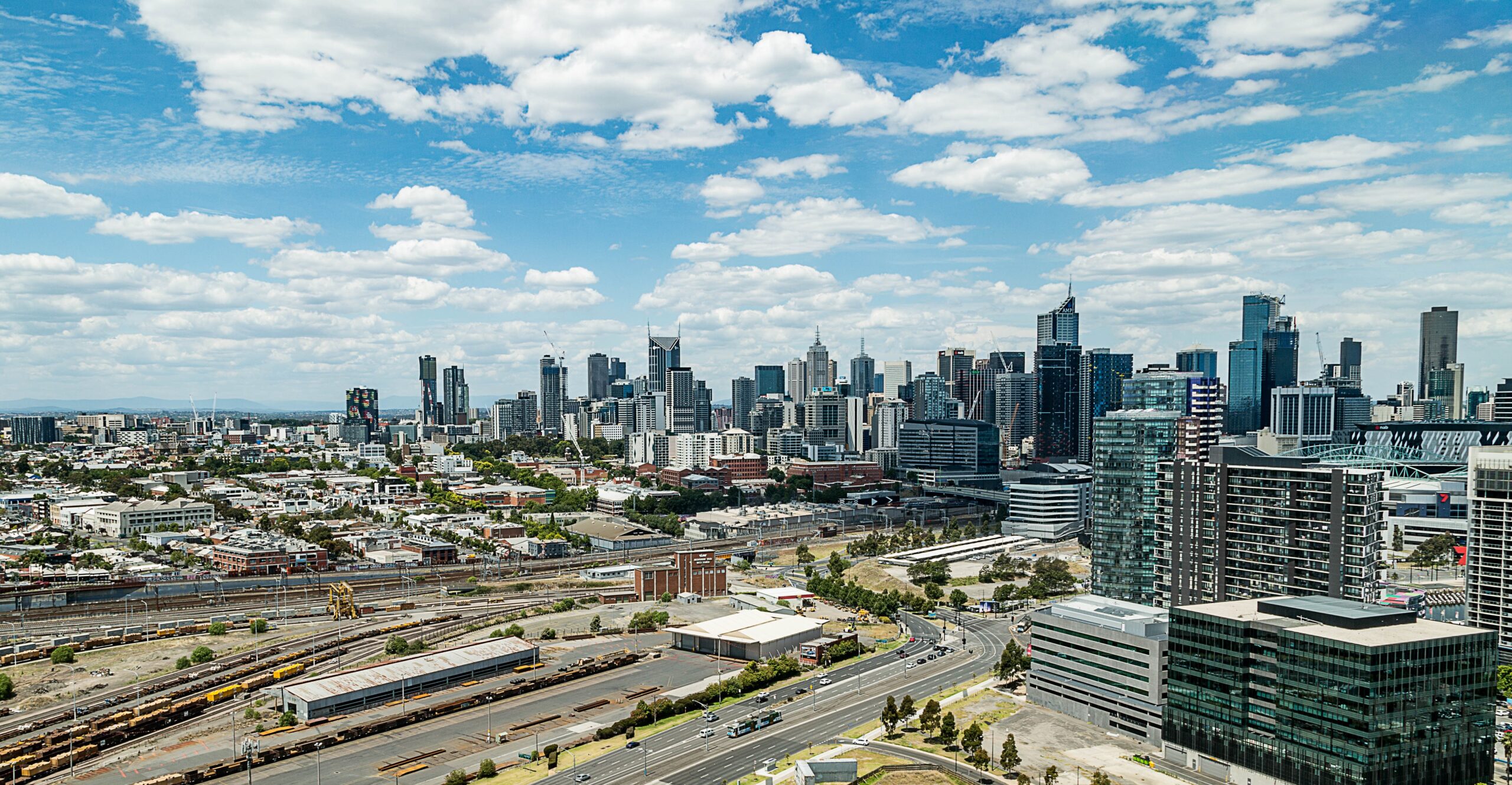 The Melbourne skyline in daytime, with many high rise buildings clustered together in the middle.