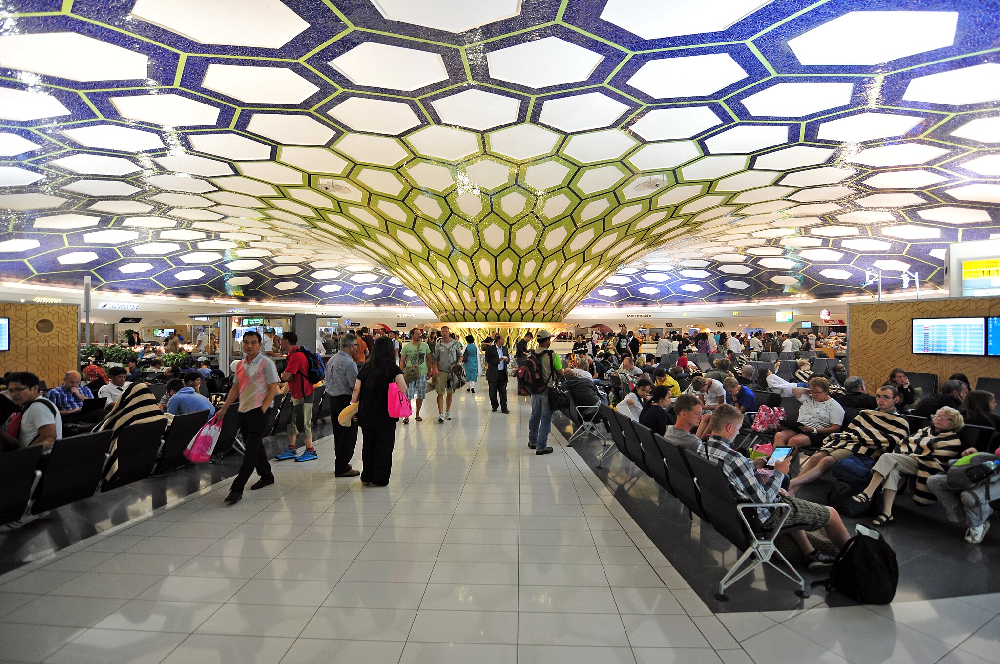 Inside Abu Dhabi airport, there is a glass sculpture made of hexagonal panels that form a collumn connecting the floor and the celing.