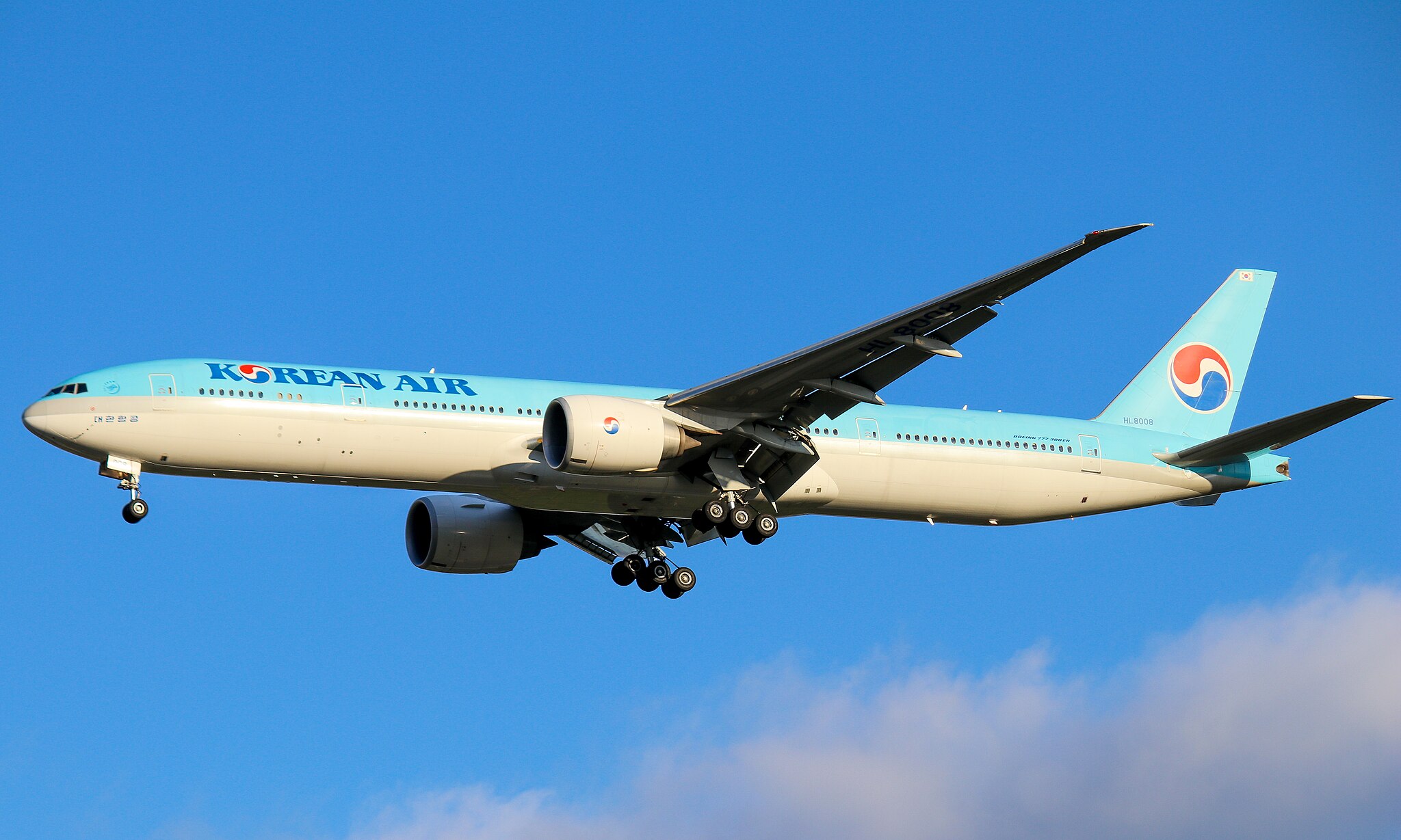 A Korean Air plane on final approach to the runway.