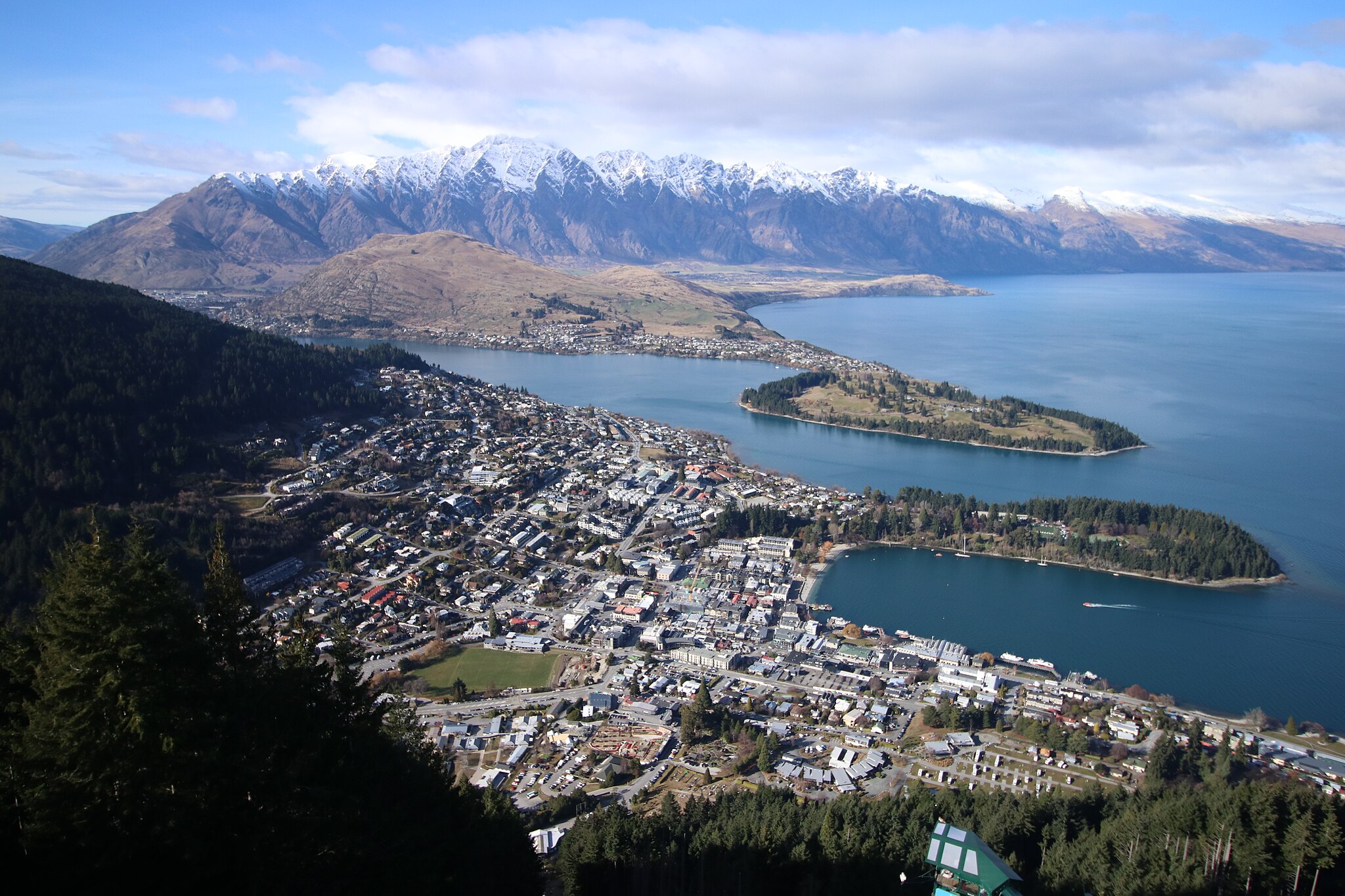 An aerial view of Queenstown on the South Island, NZ, with mountains in the background.