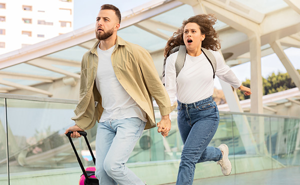 A photo of Wizz Air Pink Friday promotion with two people running in an airport looking worried