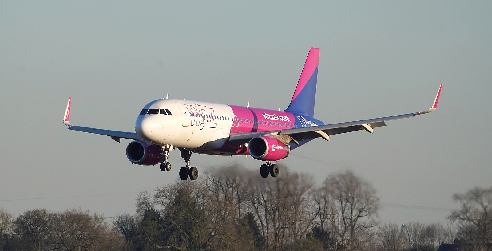 A Wizz Air Aircraft bathed in the evening winter light at Elmdon