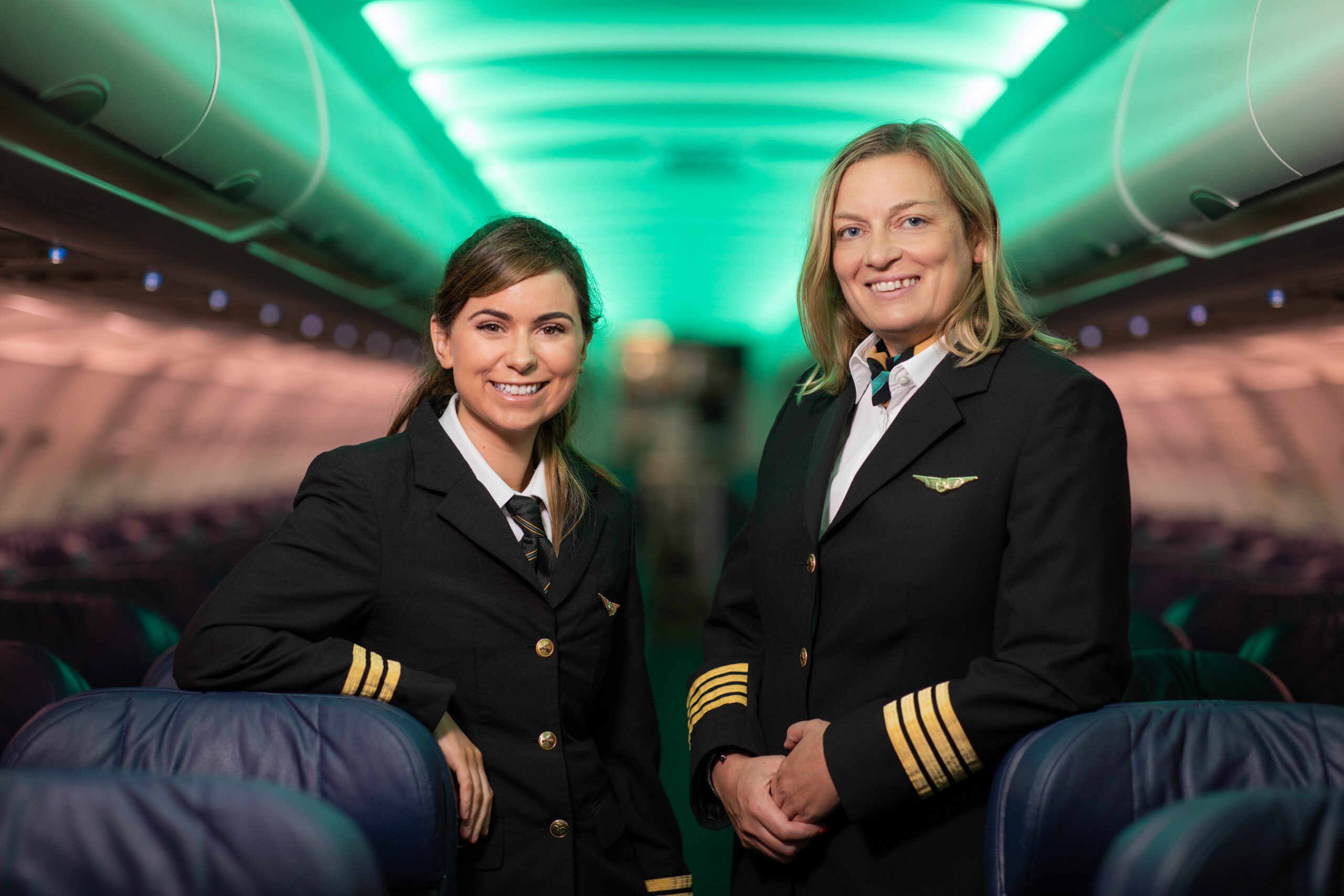 Two Aer Lingus pilots in uniform standing inside an aircraft cabin, representing Aer Lingus pilots amid ongoing Aer Lingus industrial relations and pilot dispute discussions.