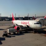 An A320 Avianca airbus stationary at an airport.