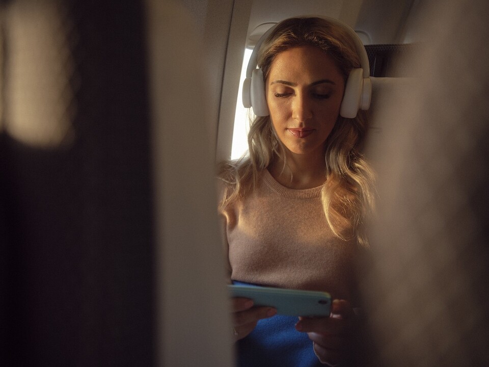A passenger enjoying Wi-Fi connections in the BA World Traveler cabin.