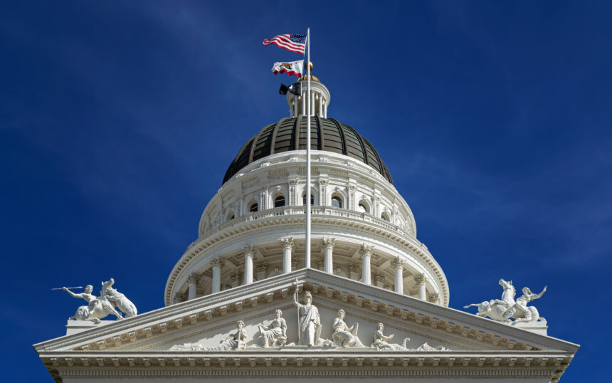 Close-up view of the California State Capitol dome with the U.S. and California flags flying above, symbolising government decisions affecting the U.S. government shutdown and national aviation crisis.