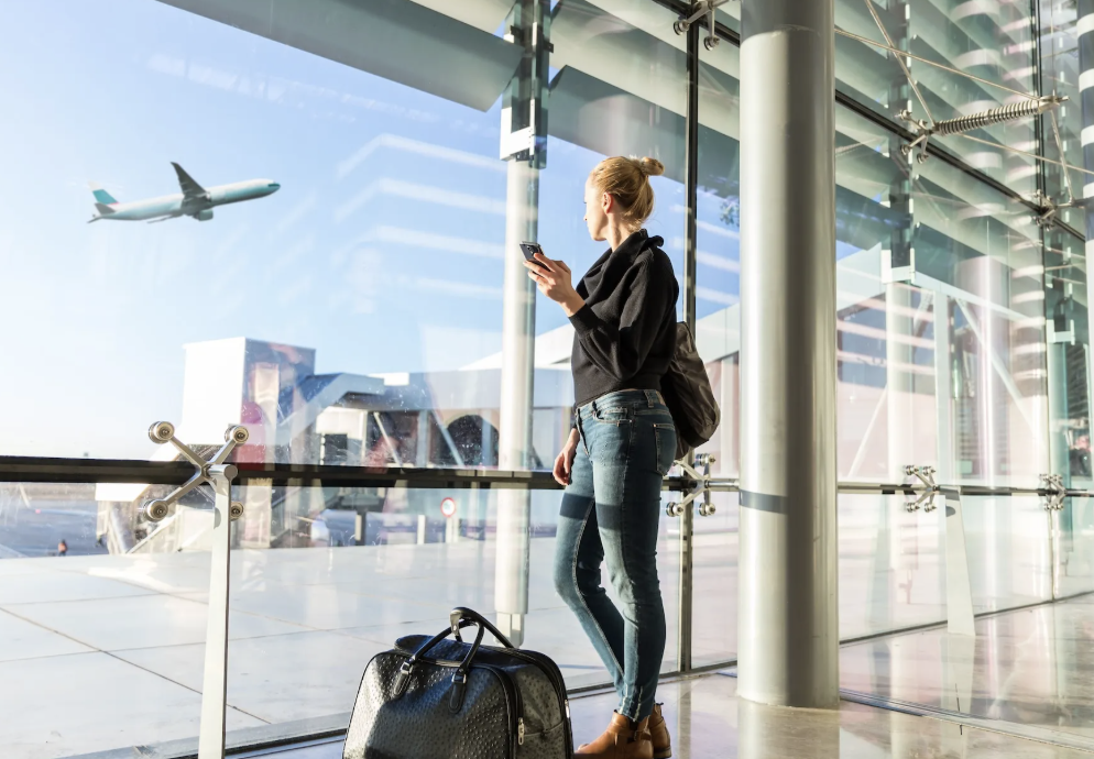 woman in terminal looking at plane