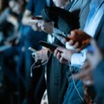 People using phone while standing