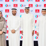 Executives of Emirates and ENOC stand together for a photograph