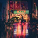 Side View of Woman in Illuminated City at Night in Tokyo, Japan