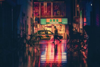 Side View of Woman in Illuminated City at Night in Tokyo, Japan