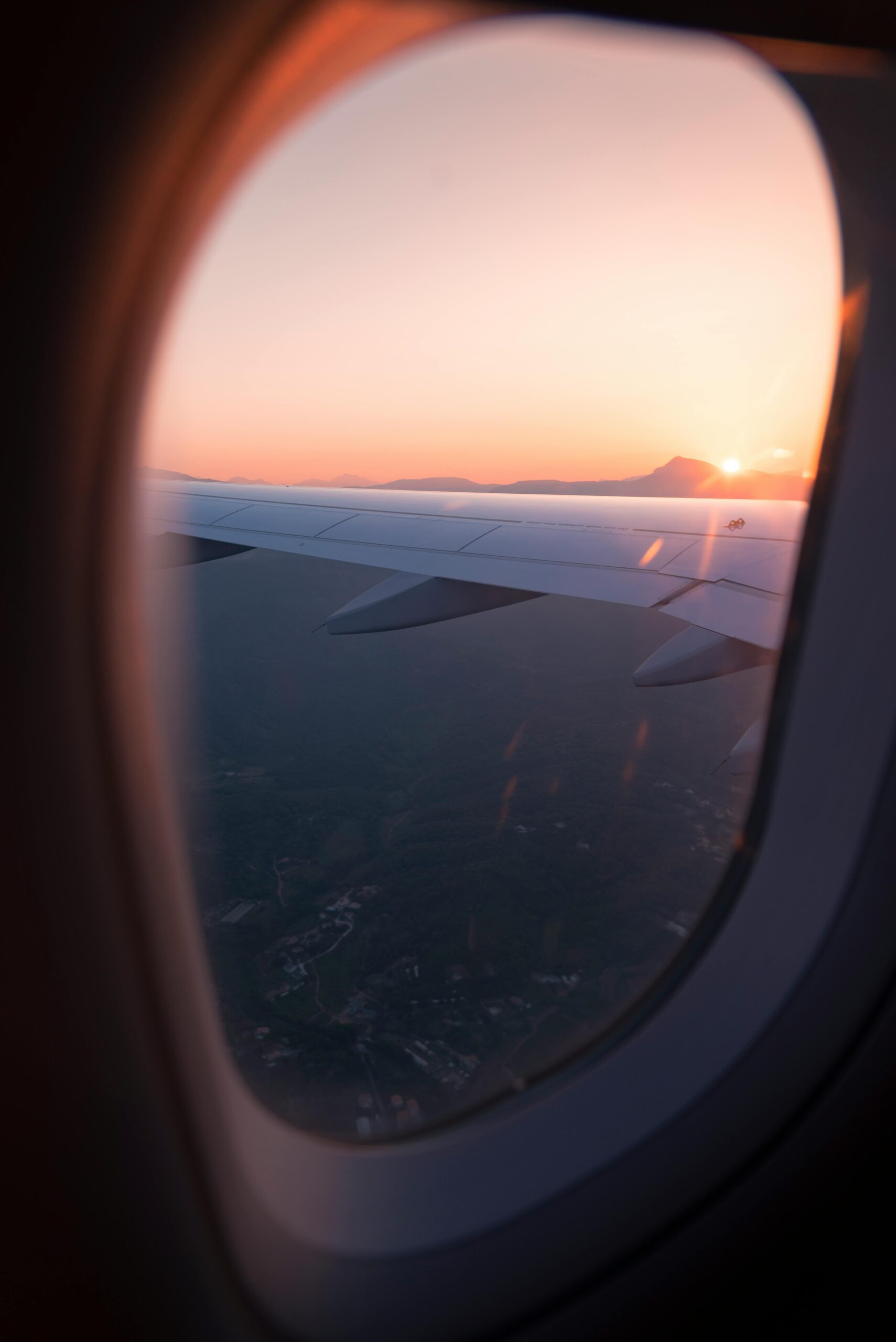 A picture of a sunset seen from inside of an aircraft