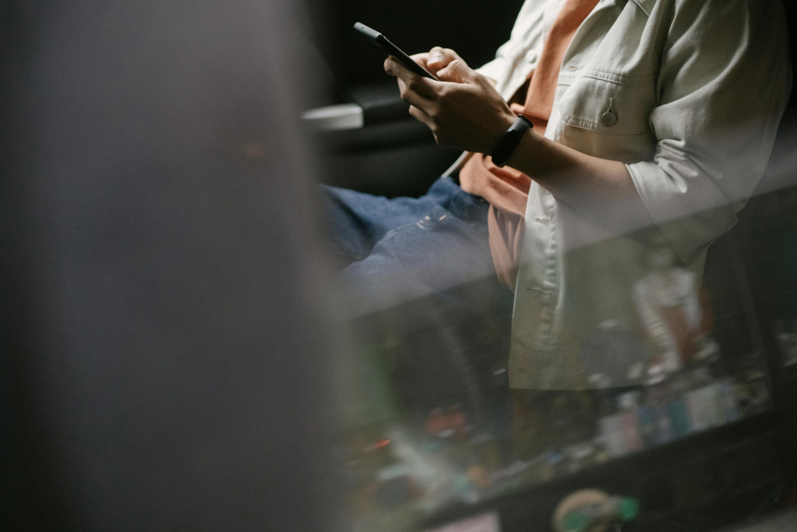 Man messaging on smartphone while sitting in car