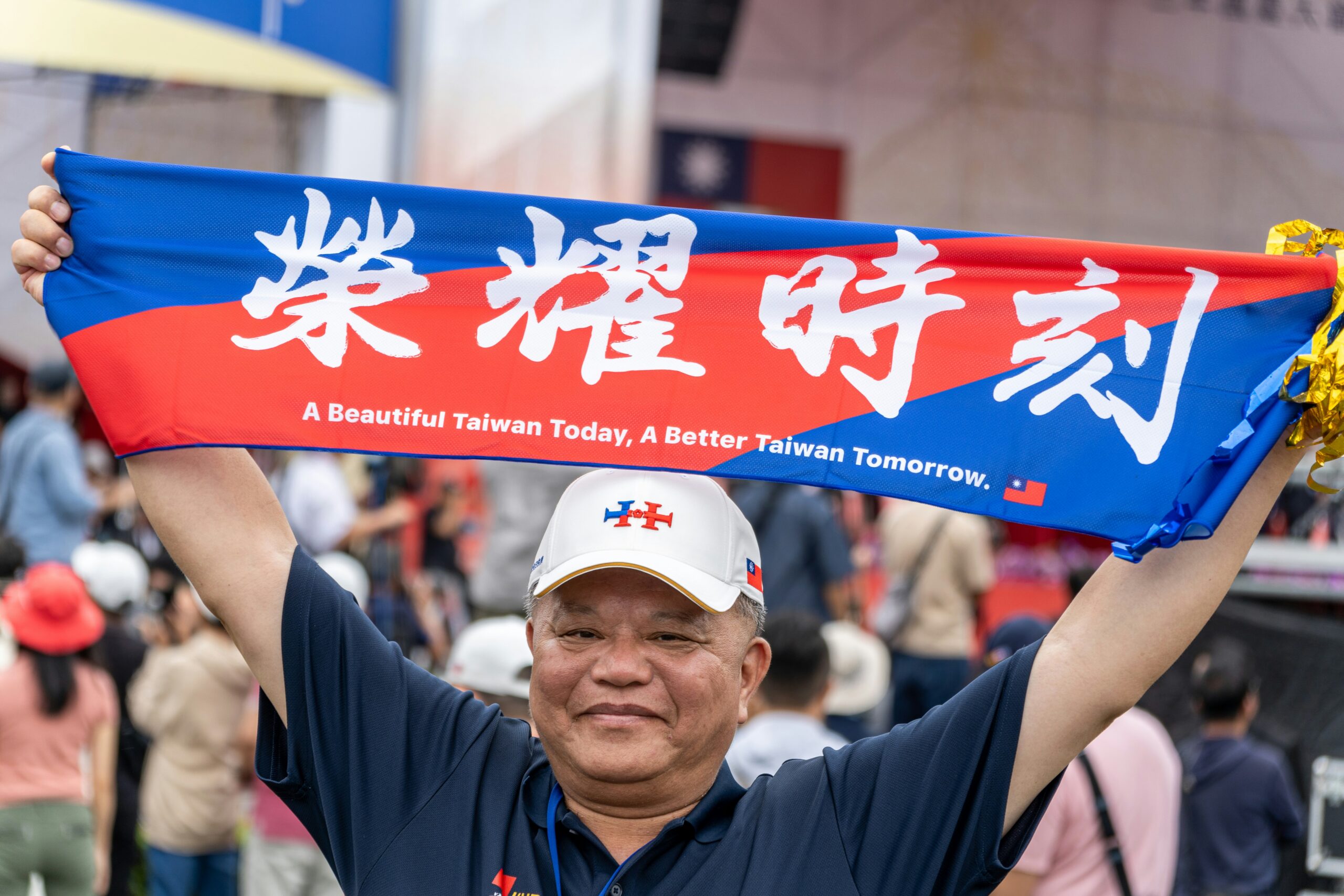 A man holding a Taiwan banner above his head 