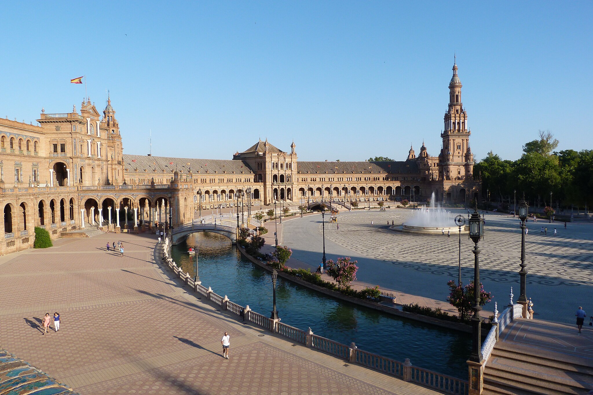 The Plaza de España in Seville, a plaza in Seville, Spain, which includes a canal around the edge and pavillion buildings with Spanish and islamic motifs.