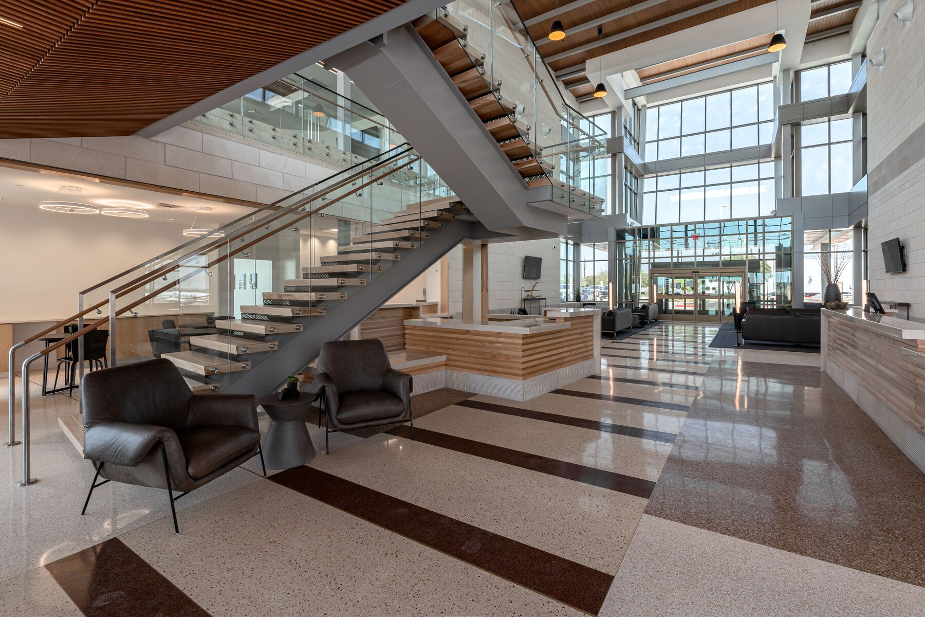 An airport lobby with chairs and desks.