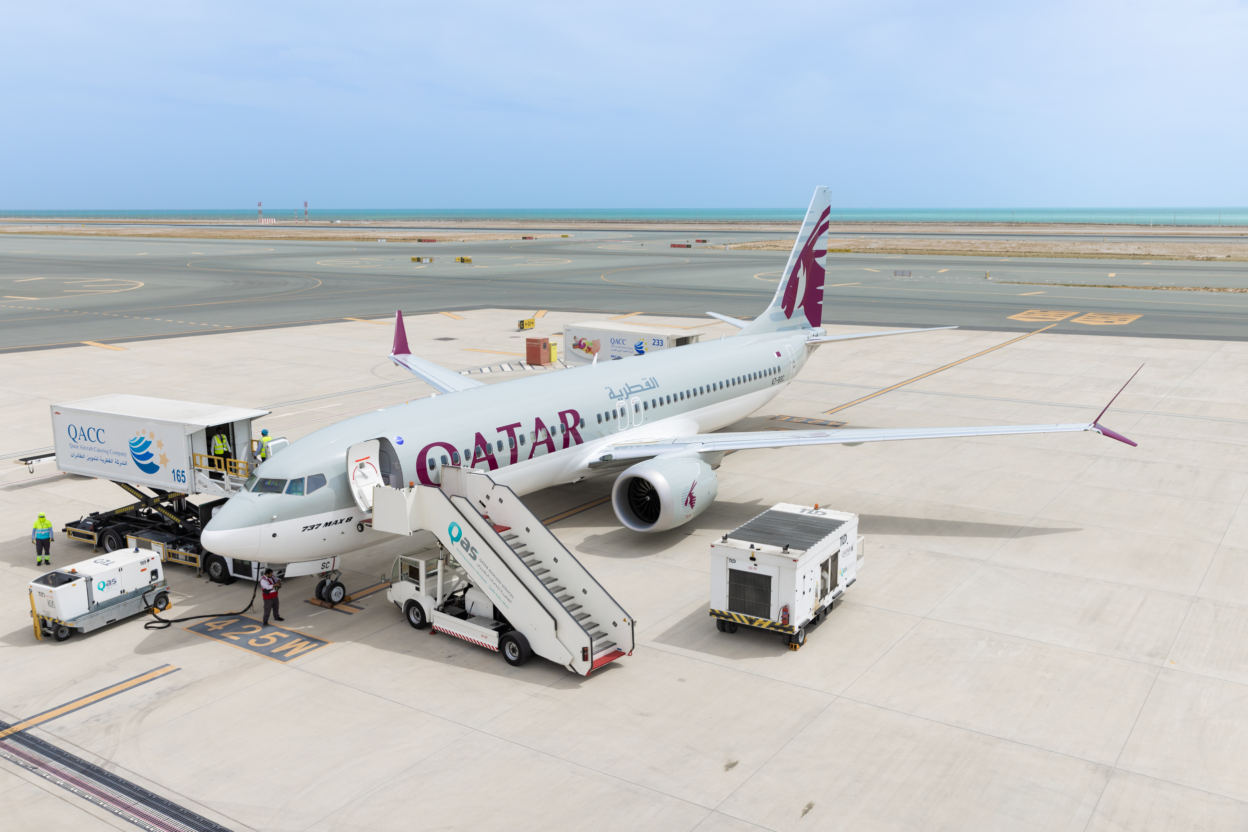 Qatar Airways 737-MAX aircraft stationed at an airport