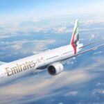 An aircraft flying over the clouds