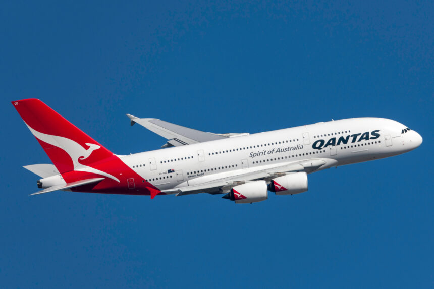 An Airbus A380 flying against a clear blue sky.