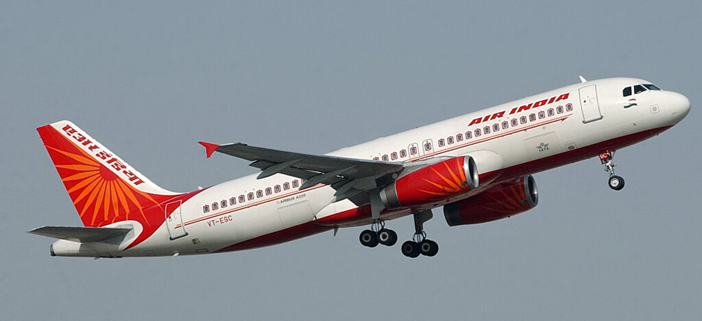 Air India A320-200 in flight with it's white, red and orange livery.