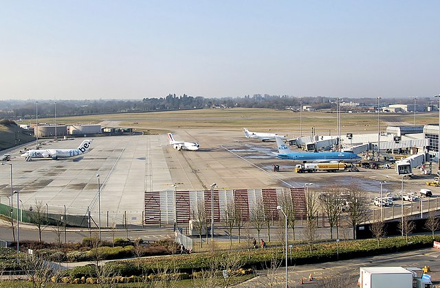 Part of the apron at Birmingham International Airport, England. The runway is seen beyond. The airlines seen are FlyBe, KLM and Air France.