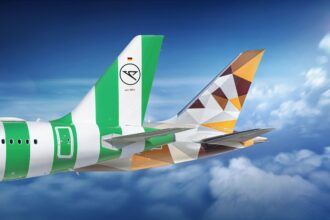 Tails of Condor and Etihad aircraft flying in the sky, showcasing both airlines’ branding.