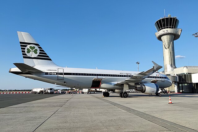 Aer Lingus Airbus A320 parked underneath the control tower.