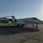 Air Charter Scotland Bombardier Challenger 350 (9H-MRT) parked on the tarmac at an airport, viewed from the side with the aircraft ready for departure.