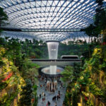 Rain Vortex inside the "Jewel" area at Changi Airport. The SkyTrain connecting Terminal 2 and 3 is visible in the photo.