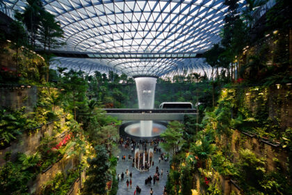 Rain Vortex inside the "Jewel" area at Changi Airport. The SkyTrain connecting Terminal 2 and 3 is visible in the photo.