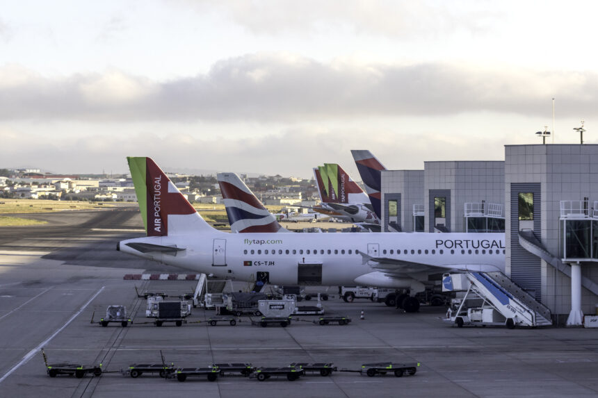 Several TAP Air Portugal aircrafts can be seen parked close to the plaftorms at the Lisbon Airport.