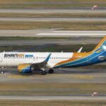 Shankh Air aircraft on the tarmac, with a tail painted yellow-to-blue